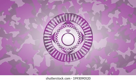 diamond ring icon inside pink and purple camo emblem. 