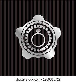 diamond ring icon inside silvery emblem or badge