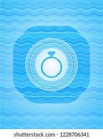 diamond ring icon inside sky blue water wave style emblem.