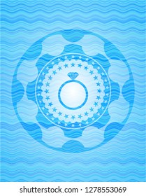diamond ring icon inside sky blue water wave emblem.
