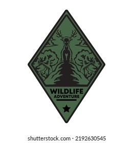 Diamond shaped emblem of standing deer on the rock