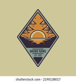 Diamond shaped emblem of sunset at the beach