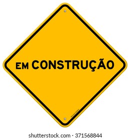 Diamond shaped symbol of bright yellow and black em construcao sign with over white background - in English saying Under Construction