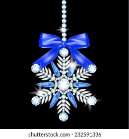 Diamond snowflake with bow hanging on black background