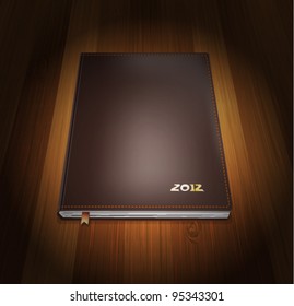  Diary in cover leather on wooden background