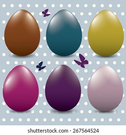 Different color Easter eggs on a spotty background.