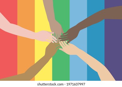 Different colour hands on rainbow Pride flag. Variety of hands connect on rainbow background. LGBTQ concept.  Equality and love protection.