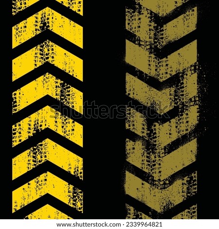 Different grunge arrows with yellow tire tracks isolated on black background