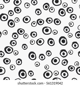 Different grunge rings with dots on white, vector seamless hand-drawn pattern, abstract ink brush stroke background