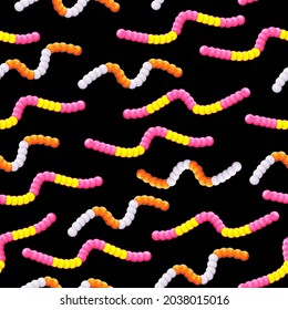Different jelly worms on a dark background. Gummy candy seamless pattern. A children treat. Vector illustration.