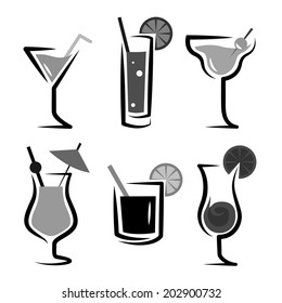 Different kinds of glasses with aperitifs, cocktails, decorated by fruit, black and white