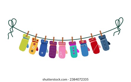 Different mittens hanging on the rope. Wool winter gloves mittens dry and hang on laundry string with clothespins.