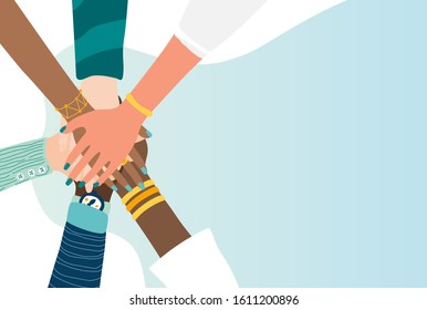 Different people join hands in a fit of teamwork. A group of people strives for a common goal in their work. Together strength, confidence and result. Friendship and helping each other in unity.