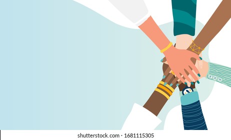 Different people join hands in a fit of teamwork. A group of people strives for a common goal in their work. Together strength, confidence and result. Friendship and helping each other in unity.