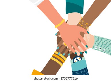 Different people join hands in a fit of teamwork. A group of people strives for a common goal in their work. Together strength, confidence and result. Friendship and helping each other in unity.