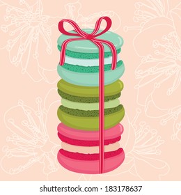 Different tastes and colors macaroons tied with a bow. Sensitive flower background. Vector illustration.