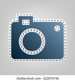 Digital camera sign. Vector. Blue icon with outline for cutting out at gray background.