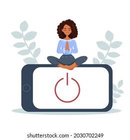 Digital detox concept. A black woman meditates in the lotus position. Informational detoxification and meditation. Rejection of gadgets, devices, the Internet, communication in social networks