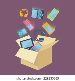 Digital devices as laptop, desktop computer, mobile phones, headset and portable music players falling into an open card board box