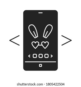 Digital face application black glyph icon. Photo filter bunny ears in smartphone. Pictogram for web page, mobile app, promo. UI UX GUI design element.