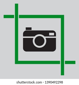 Digital photo camera sign. Black icon inside green crop tool at light gray background