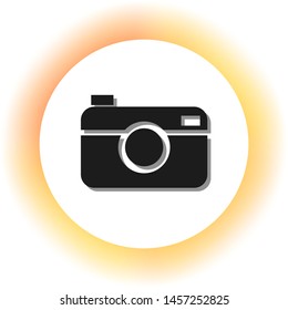 Digital photo camera sign. Dark icon with shadow on the glowing circle button. Illustration.