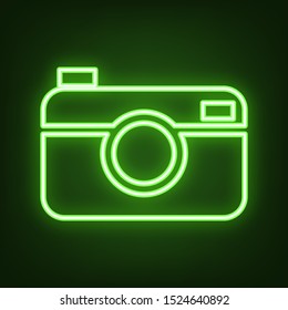 Digital photo camera sign. Green neon icon in the dark. Blurred lightening. Illustration.