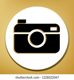 Digital photo camera sign. Vector. Black icon with light brown shadow in white circle with shaped ring at golden background.