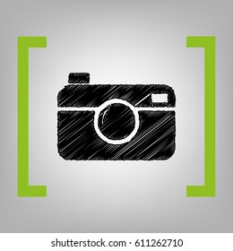 Digital photo camera sign. Vector. Black scribble icon in citron brackets on grayish background.