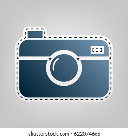 Digital photo camera sign. Vector. Blue icon with outline for cutting out at gray background.