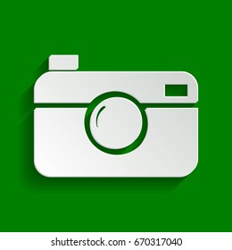 Digital photo camera sign. Vector. Paper whitish icon with soft shadow on green background.