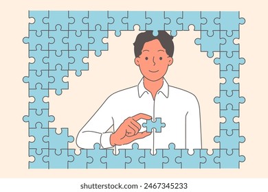 Diligent business man puts together puzzle, demonstrating mind and intelligence required to solve complex problem. Business guy working in large corporation gradually solves task step by step
