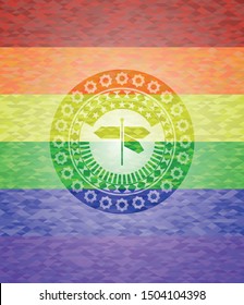directions sign icon inside emblem on mosaic background with the colors of the LGBT flag