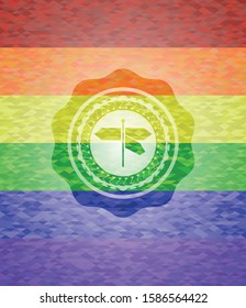 directions sign icon inside emblem on mosaic background with the colors of the LGBT flag