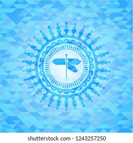 directions sign icon inside light blue mosaic emblem