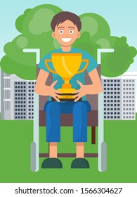 Disabled boy on wheelchair holding winner cup and smiling. Happy champion with incapacitation win goblet.