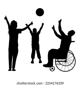 A disabled man in a wheelchair plays ball with a child and a woman at dawn. Happy family concept