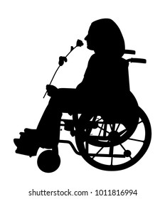 Disabled person in wheelchair smelling rose and waiting for someone to come