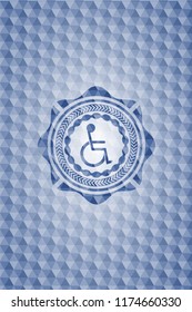 disabled (wheelchair) icon inside blue polygonal emblem.