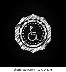 disabled (wheelchair) icon inside chalk emblem written on a blackboard