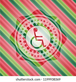 disabled wheelchair icon inside christmas style emblem.
