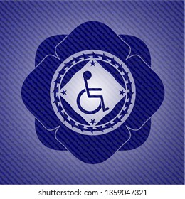 disabled (wheelchair) icon inside emblem with denim high quality background