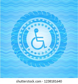 disabled (wheelchair) icon inside light blue water wave emblem background.