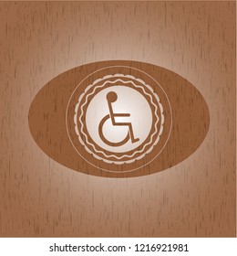 disabled (wheelchair) icon inside realistic wooden emblem
