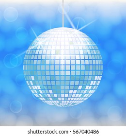Disco ball isolated on light blue background with light cloudy circles like bokeh effect