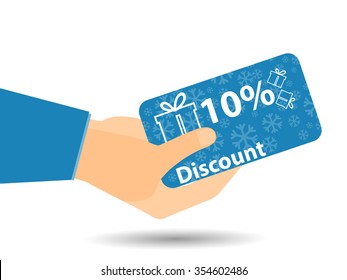 Discount coupons in hand. 10-percent discount. Special offer. Snowflakes and gift boxes.