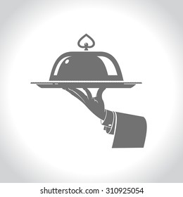 The dish in the hand of the waiter. Vector logo, silhouette.