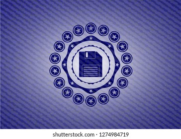 diskette icon inside badge with denim background