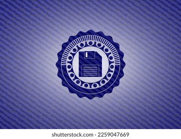 diskette icon inside badge with denim texture. 
