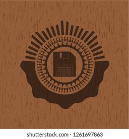 diskette icon inside badge with wooden background